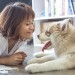 girl and dog smiling at each other